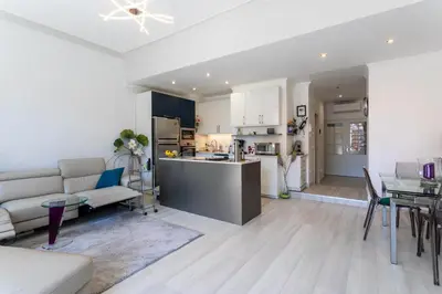 a living room and kitchen with a couch and a table at PORT CARNOT AP4405 By Riviera Holiday Homes in Nice