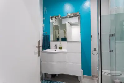 a bathroom with a white sink and a mirror at PORT CARNOT AP4405 By Riviera Holiday Homes in Nice