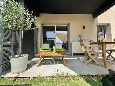 a patio with a table and chairs and a table at Art Studio Nice in Nice