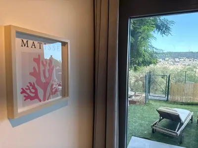 a window with a picture of a chair next to a door at Art Studio Nice in Nice