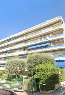 a large white building with trees in front of it at oliveraie in Nice