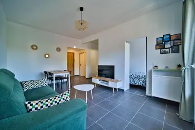 a living room with a couch and a table at oliveraie in Nice
