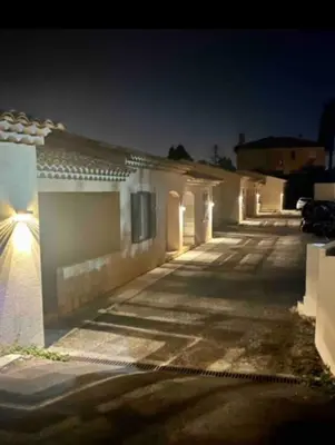a row of buildings at night with lights on them at DOMAINE LOU BEL AZUR - Elégant in Saint-Laurent-du-Var