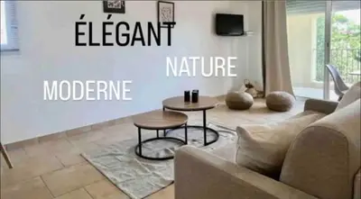 a living room with a couch and a table at DOMAINE LOU BEL AZUR - Elégant in Saint-Laurent-du-Var