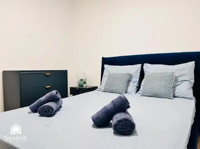 a bed with three purple pillows on it at Charming Downtown - AC - WiFi - Private Entrance in Nice