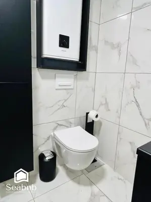 a bathroom with a white toilet in a stall at Charming Downtown - AC - WiFi - Private Entrance in Nice