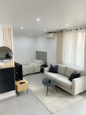 a living room with a couch and a bed at République in Nice