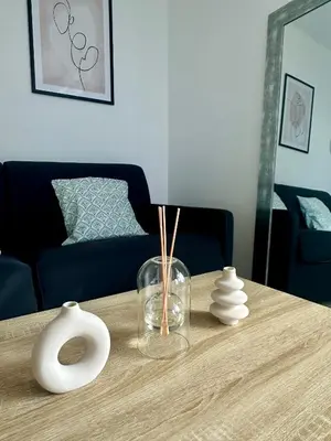 a wooden table with a vase and vases on it at Cosy studio avec parking et vue féerique in Nice