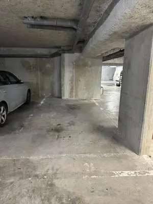 a parking garage with a car parked in it at Cosy studio avec parking et vue féerique in Nice
