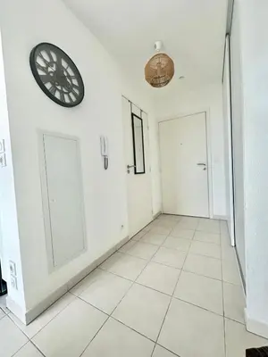 a room with two doors and a clock on the wall at Cosy studio avec parking et vue féerique in Nice