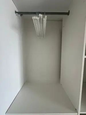a white closet with a light hanging from the ceiling at Cosy studio avec parking et vue féerique in Nice