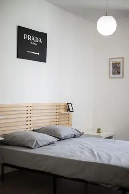 a bedroom with a bed with a sign on the wall at Magnifique 3 pièces de 80m2 dans le Carré d'Or in Nice