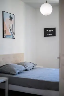 a bedroom with a bed with blue sheets and a lamp at Magnifique 3 pièces de 80m2 dans le Carré d'Or in Nice