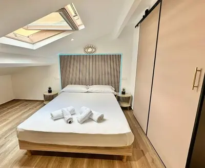 a bedroom with a bed with towels on it at Appartement climatisé - 2min plage-tram-restaurant in Nice