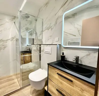 a bathroom with a sink and a toilet and a mirror at Appartement climatisé - 2min plage-tram-restaurant in Nice