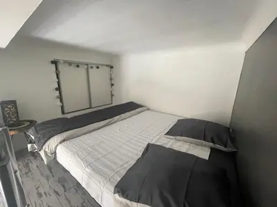a small bedroom with a bed and a mirror at Malyandco in Nice