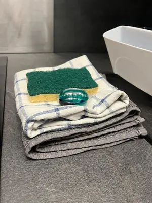 a pile of towels sitting on a counter in a bathroom at Studio piscine climatisation tennis in Nice