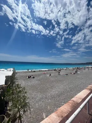 a group of people laying on a beach at Studio Palais de la Méditerranée in Nice