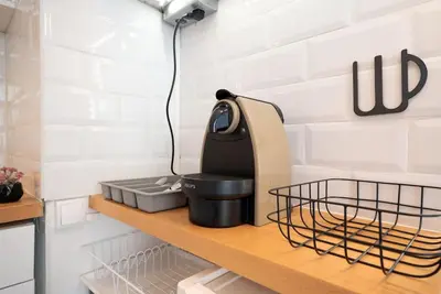 a kitchen counter with a kitchen appliance on a shelf at Cocon Urbain - Près de la Gare in Nice