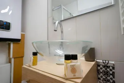 a bathroom sink with a glass bowl on a counter at Cocon Urbain - Près de la Gare in Nice