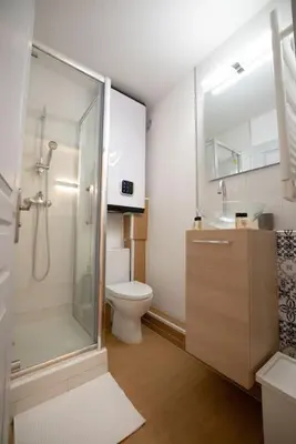 a bathroom with a shower and a toilet and a sink at Cocon Urbain - Près de la Gare in Nice