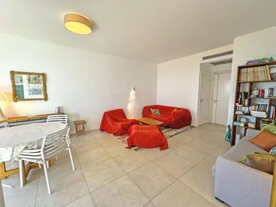 a living room with a couch and a table at Cosy Sea Front Garden Nice in Nice