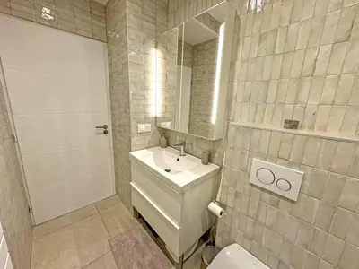 a bathroom with a sink and a toilet and a mirror at Cosy Sea Front Garden Nice in Nice