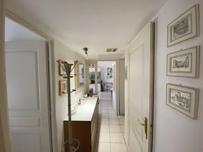 a hallway with a bathroom with a sink and a room at Nice Magnan 2P-Piscine, Clim, Parking in Nice