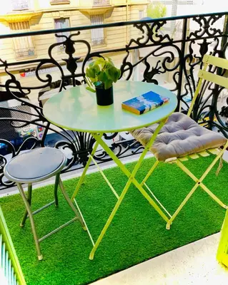 a table and a chair on a balcony at À 2 pas du centre in Nice