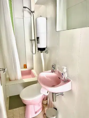 a pink bathroom with a toilet and a sink at À 2 pas du centre in Nice