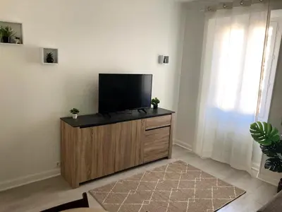 a living room with a flat screen tv on a wooden cabinet at À 2 pas du centre in Nice