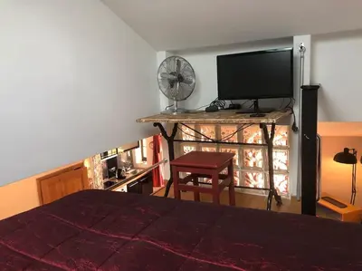 a bedroom with a bed and a flat screen tv at Balcony last floor harbour Nice parking on demand in Nice