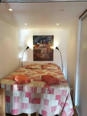 a bedroom with a bed with a painting on the wall at Balcony last floor harbour Nice parking on demand in Nice