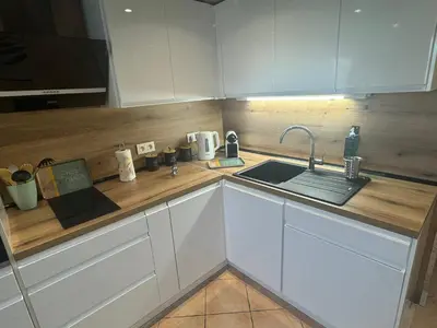 a kitchen with white cabinets and a sink at Duplex proche port de Nice in Nice