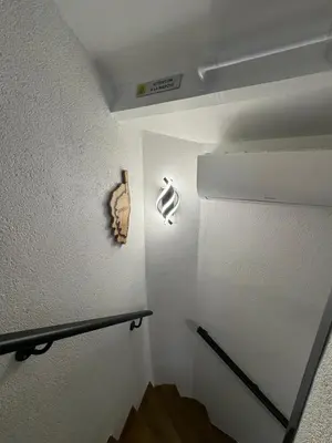a bathroom with a sign on the wall next to a room at Duplex proche port de Nice in Nice