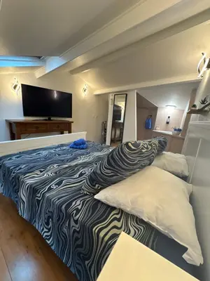 a bedroom with a large bed with two pillows at Duplex proche port de Nice in Nice