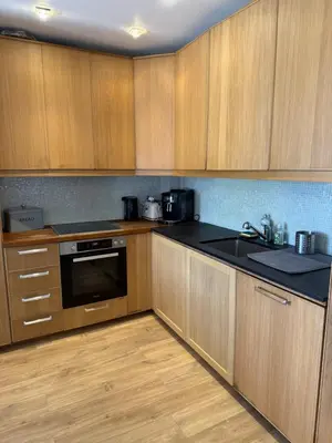a kitchen with wooden cabinets and a sink at Magnifique villa pieds dans l eau Saint Jean Cap Ferrat in Saint-Jean-Cap-Ferrat