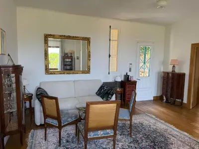 a living room with a couch and a mirror at Magnifique villa pieds dans l eau Saint Jean Cap Ferrat in Saint-Jean-Cap-Ferrat