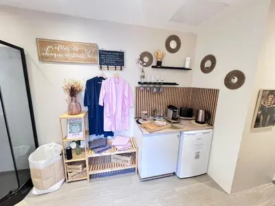 a kitchen with a refrigerator and a counter top at LOVE ROOM Tente chauffée Lodge spa MFG chez C&C, exclusivement réservée aux ADULTES in Cantaron