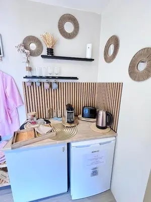 a kitchen with a counter top and a refrigerator at LOVE ROOM Tente chauffée Lodge spa MFG chez C&C, exclusivement réservée aux ADULTES in Cantaron