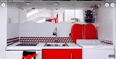 a kitchen with red and white cabinets and a sink at Studio atypique central mais calme, quartier VIP, plage 50m in Nice