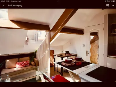 a living room with a couch and a table at Studio atypique central mais calme, quartier VIP, plage 50m in Nice