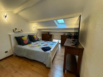 a bedroom with a bed and a desk and a window at Appartement en duplex in Nice