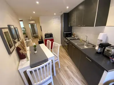 a kitchen with a table and chairs in a kitchen at 2 pièces Vieux Nice - Deux pas de la mer in Nice
