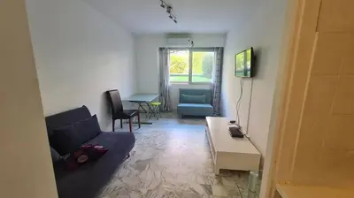 a living room with a couch and a table at Petit studio promenade des Anglais in Nice