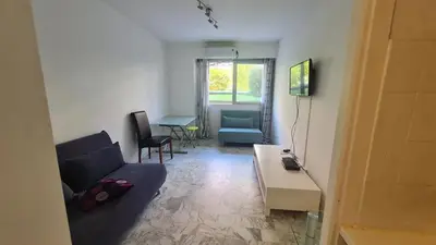 a living room with a couch and a table at Petit studio promenade des Anglais in Nice