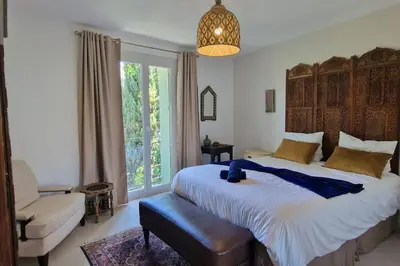 a bedroom with a large bed and a large window at Rêves d'Orient - proche mer in Nice