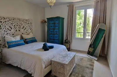 a bedroom with a bed with a blue dresser and a window at Rêves d'Orient - proche mer in Nice