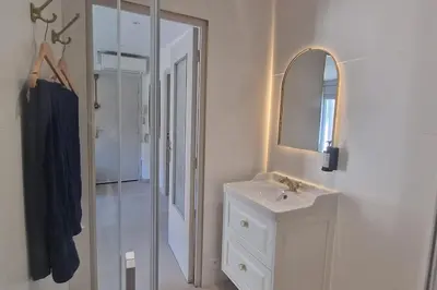 a white bathroom with a sink and a mirror at Rêves d'Orient - proche mer in Nice