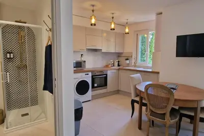 a kitchen with a table and a dining room at Rêves d'Orient - proche mer in Nice